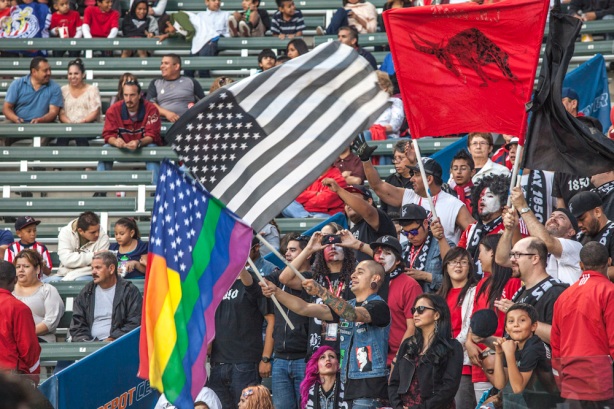 Black Army 1850 during the game, waving a rainbow-colored flag to promote it accepts any fan to join their ranks.